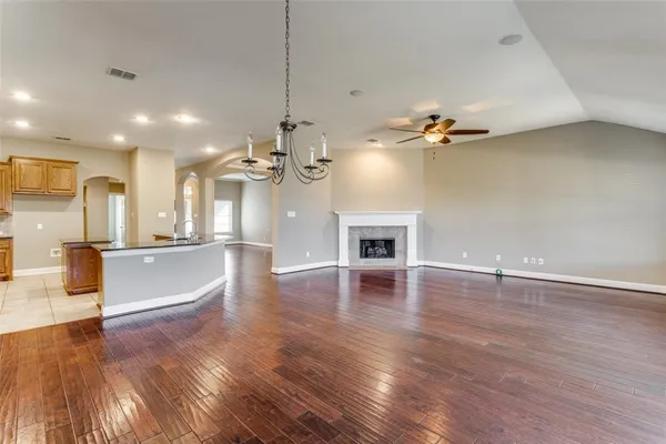 a view of a room with kitchen island and wooden floor