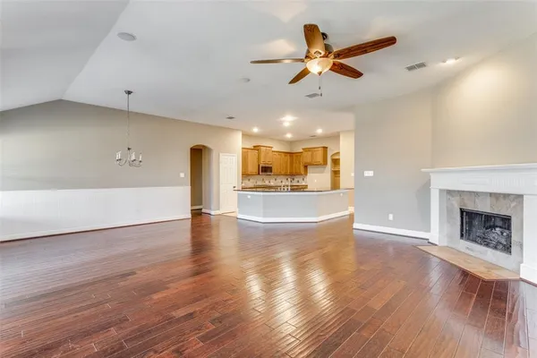 a view of a livingroom with a ceiling fan and wooden floor