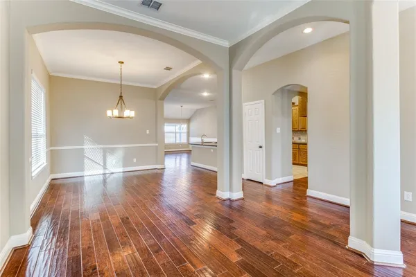 a view of an empty room and wooden floor