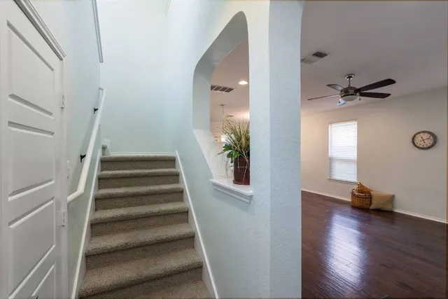 a view of entryway and hall with wooden floor