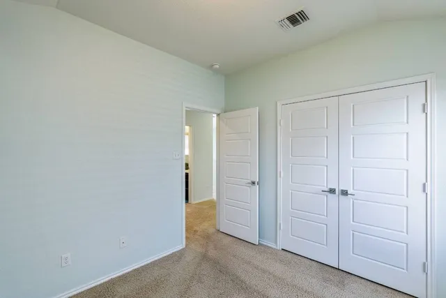 an empty room with closet area