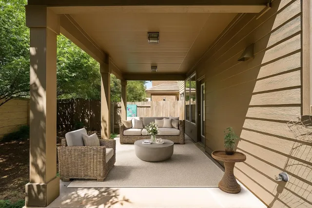 a view of a patio with couches potted plants and floor to ceiling window