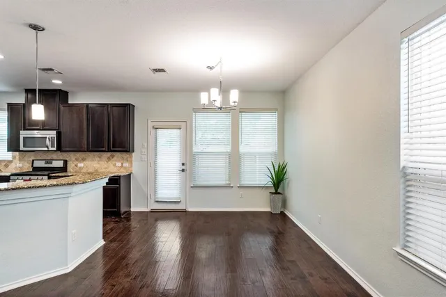 a view of kitchen with sink and wooden floor