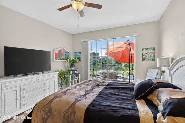 a room with furniture a bookshelf and a window