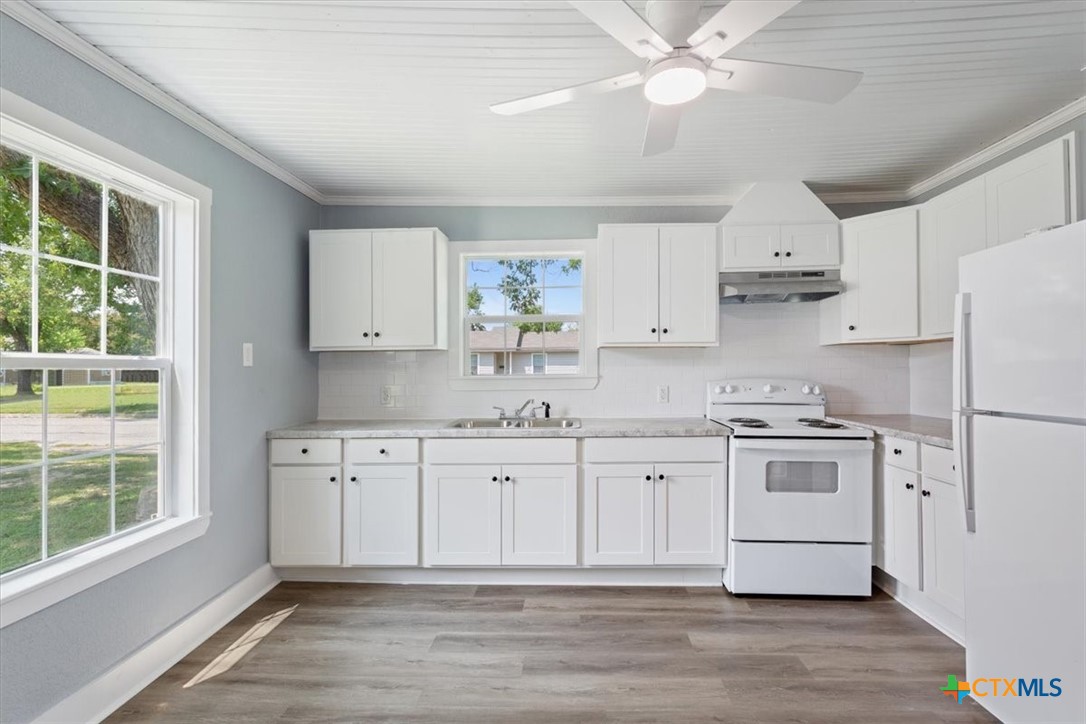 202 South 23rd Street Temple, TX 76504 - Photo 11 of 20 a kitchen with stainless steel appliances a stove a sink and white cabinets