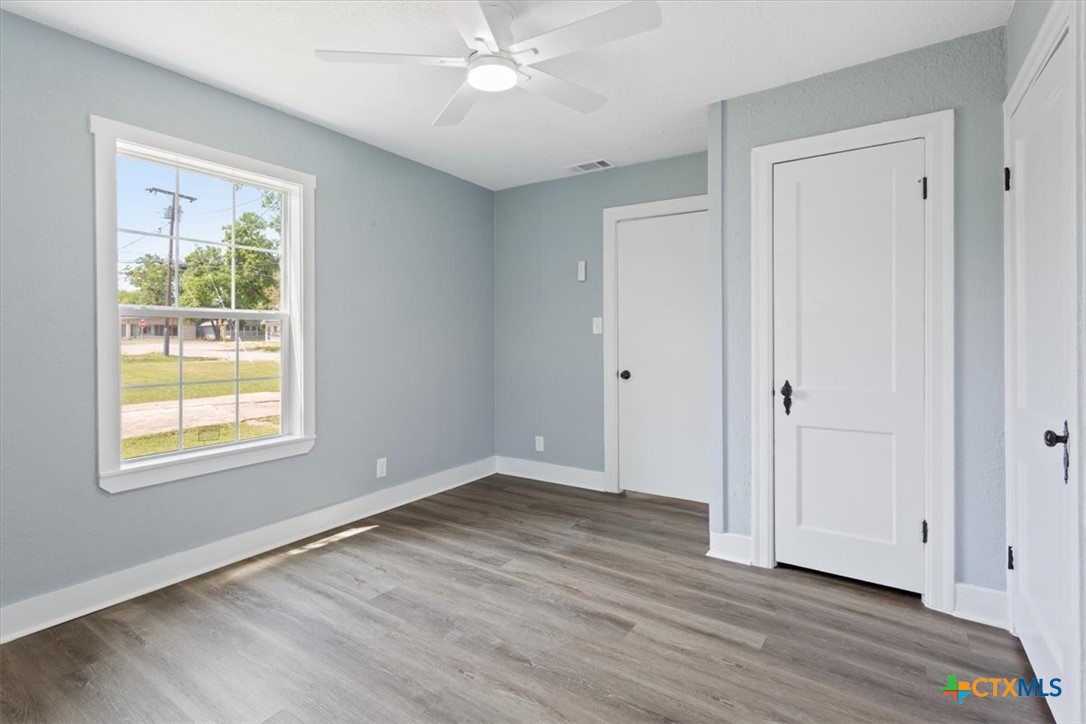 202 South 23rd Street Temple, TX 76504 - Photo 15 of 20 a view of an empty room with wooden floor and a window