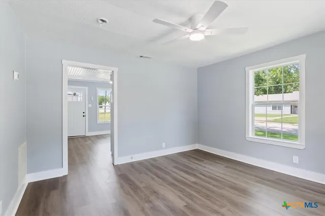wooden floor in an empty room with a window