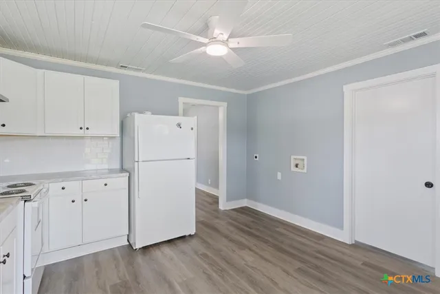 a white refrigerator freezer sitting in a kitchen