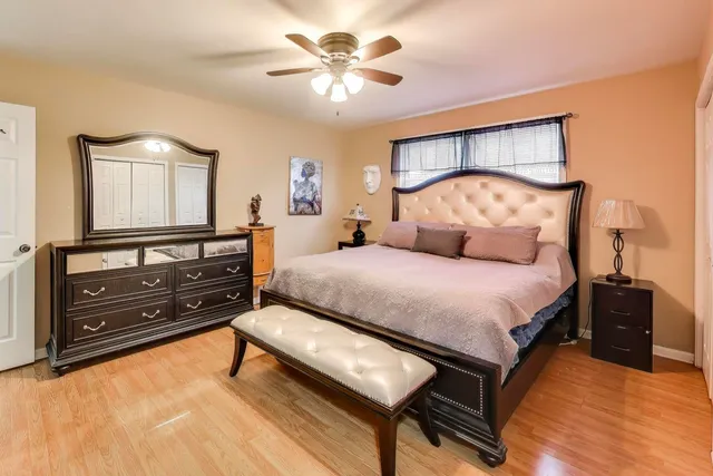 a bedroom with a bed and a flat tv screen on dresser