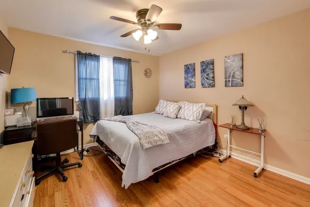 a bedroom with a bed and a desk