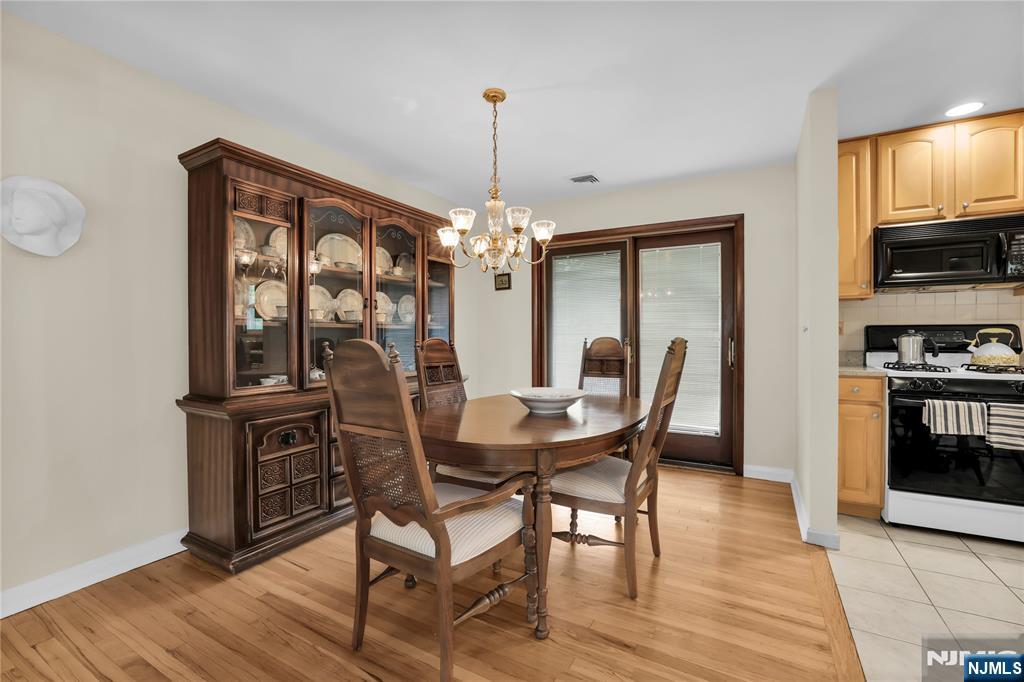 23 Ridge Court Cedar Grove, NJ 07009 - Photo 9 of 37 a view of a dining room with furniture window and wooden floor