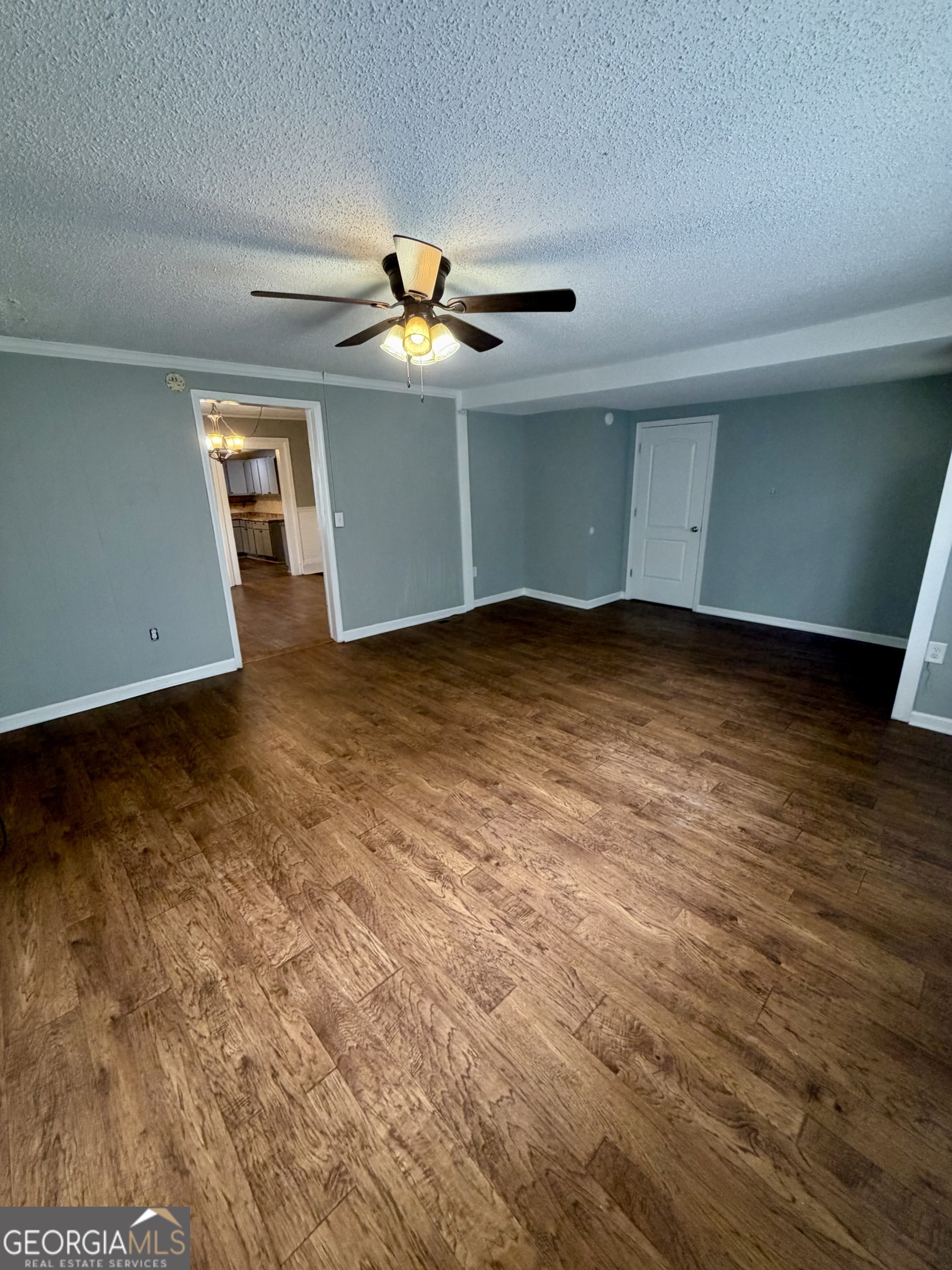 666 Woolfolk Street Macon, GA 31217 - Photo 10 of 60 a view of an empty room with window and chandelier fan