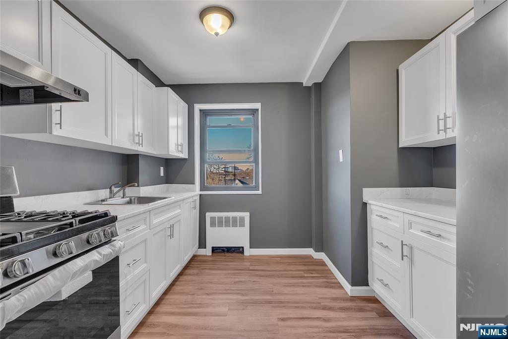 208 Anderson Street, Unit S4C Hackensack, NJ 07601 - Photo 1 of 17 a kitchen with stainless steel appliances granite countertop a stove and a refrigerator