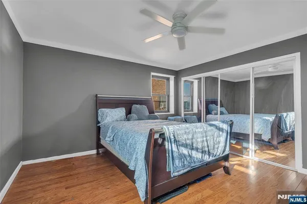 a bedroom with a large bed and a chandelier