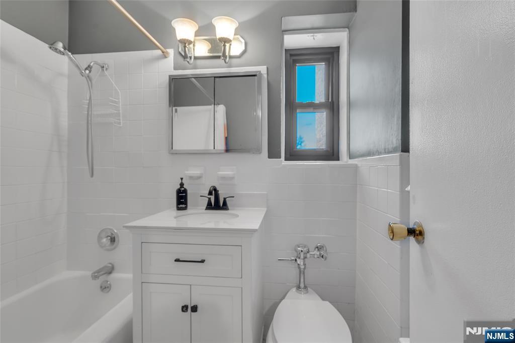 208 Anderson Street, Unit S4C Hackensack, NJ 07601 - Photo 12 of 17 a bathroom with a sink a toilet and shower