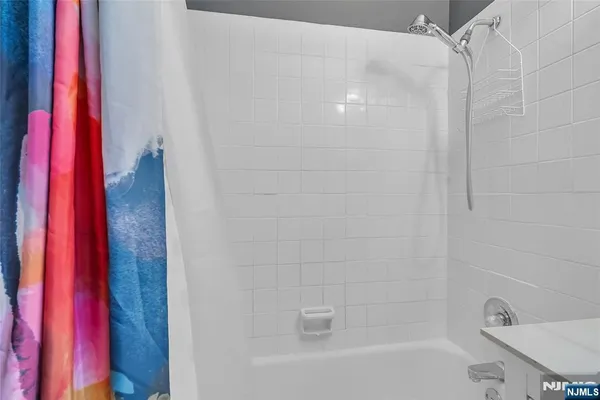 a bathroom with a bathtub and a shower