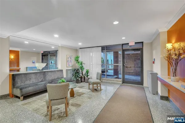 a living room with furniture a flat screen tv and a large window