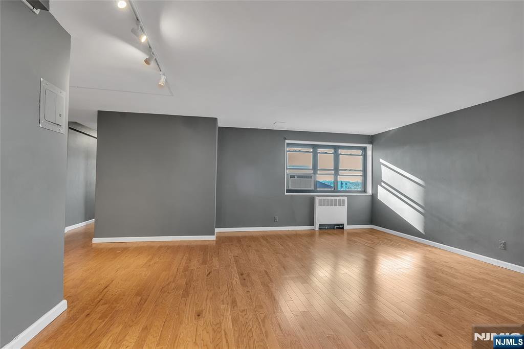 208 Anderson Street, Unit S4C Hackensack, NJ 07601 - Photo 4 of 17 wooden floor in an empty room with a window