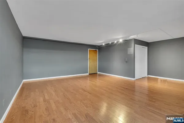 a view of an empty room with wooden floor