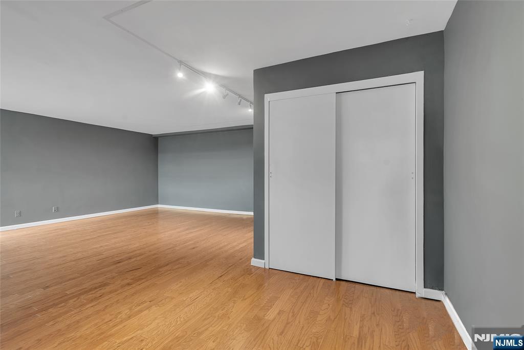 208 Anderson Street, Unit S4C Hackensack, NJ 07601 - Photo 8 of 17 a view of empty room with wooden floor