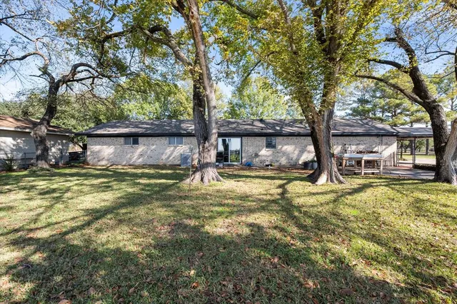 a view of a house with swimming pool and a tree