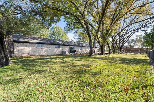 a swimming pool with outdoor seating and yard