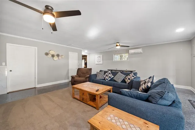 a living room with furniture and a ceiling fan