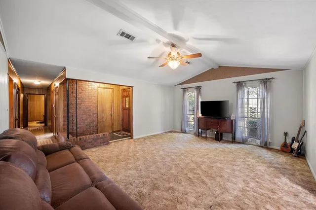 a view of a livingroom with furniture and a flat screen tv