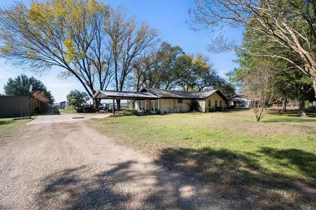 a view of house with trees in front of it