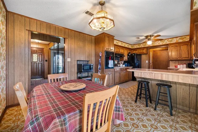 a dining area with a table and chairs