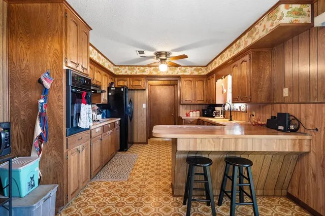 a kitchen with stainless steel appliances granite countertop a sink and cabinets