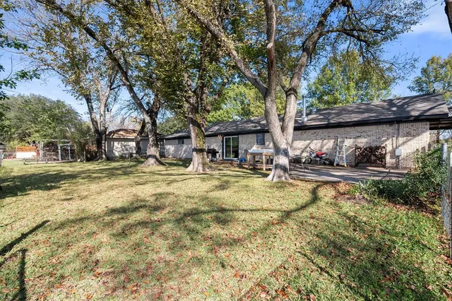 a swimming pool with outdoor seating and yard