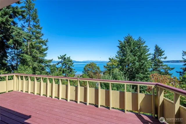a view of balcony with wooden floor and fence