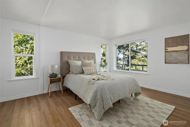 a bed sitting in a bedroom next to a window