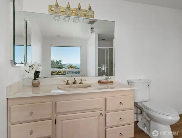 a bathroom with a sink toilet and mirror