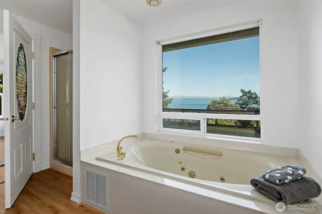 a bathroom with a bathtub and a window