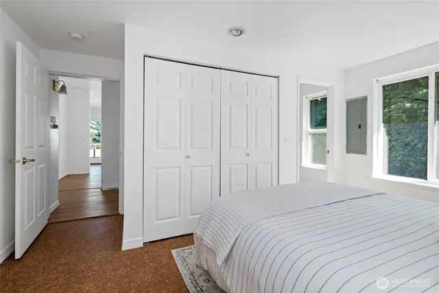 a spacious bedroom with a bed and a shower