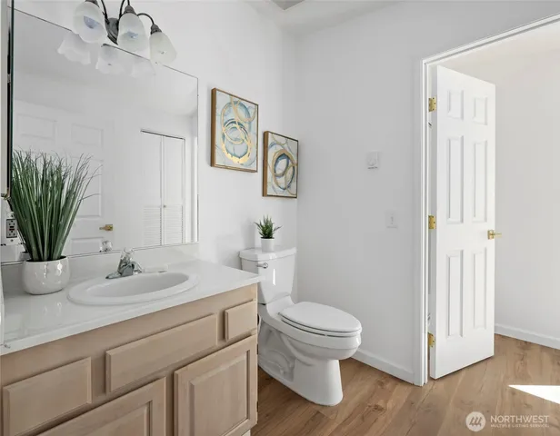 a bathroom with a toilet sink and mirror