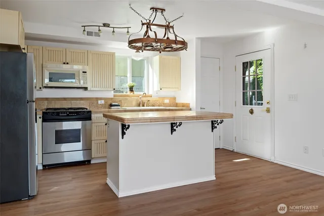 a kitchen with a sink stove and cabinets