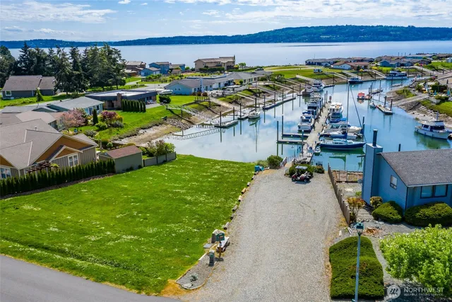 a view of a backyard with swimming pool and yard
