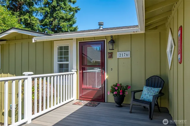 a view of a porch with furniture and wooden floor