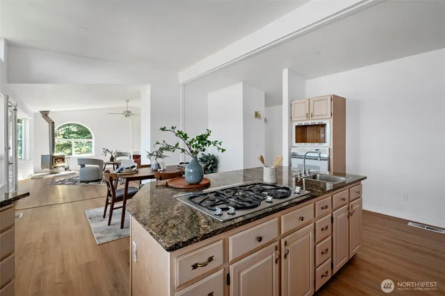 a kitchen with sink stove and cabinets