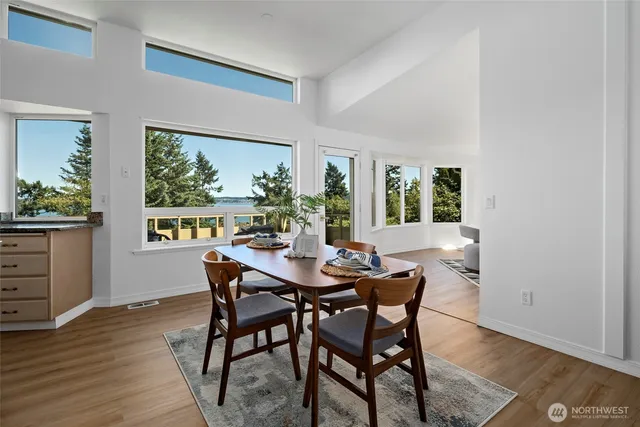 a view of a dining room with furniture window and wooden floor