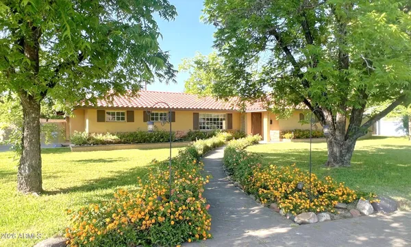 a front view of a house with garden