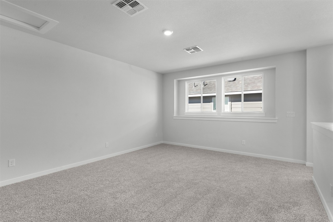 237 Wingstem Way Georgetown, TX 78633 - Photo 14 of 26 Unfurnished room with light carpet and attic access
