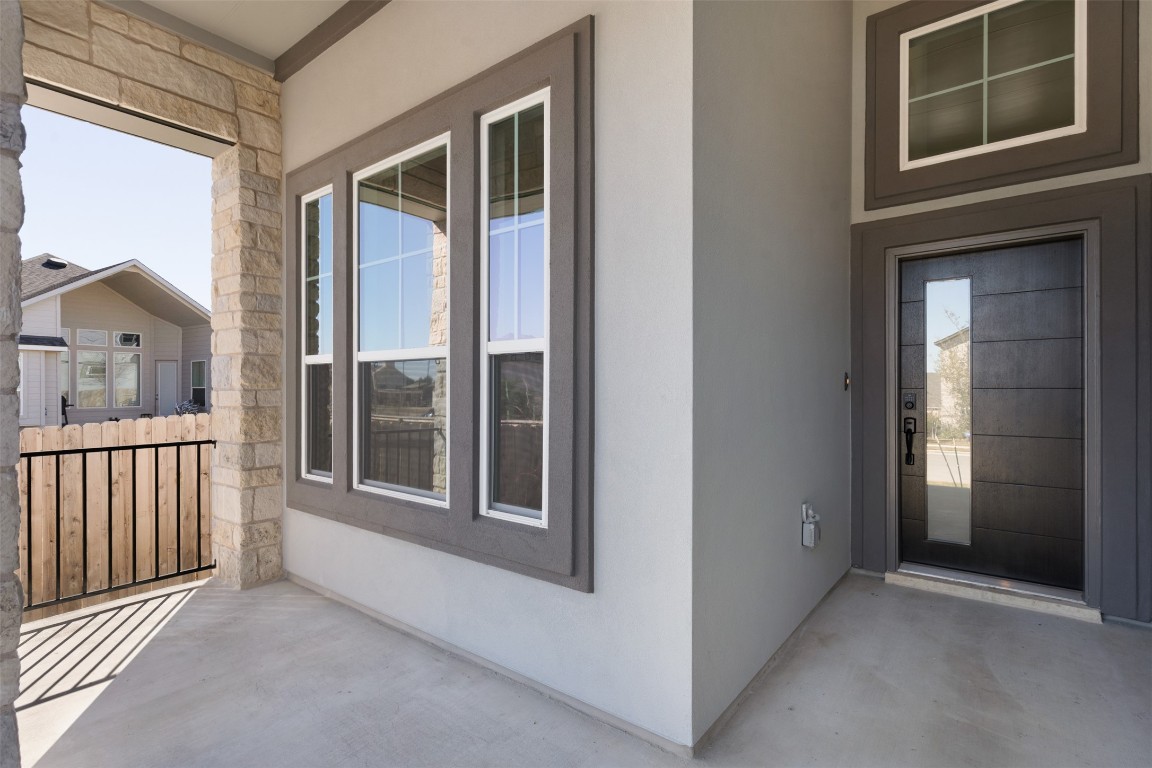 237 Wingstem Way Georgetown, TX 78633 - Photo 2 of 26 Doorway to property featuring stone siding, stucco siding, and a patio