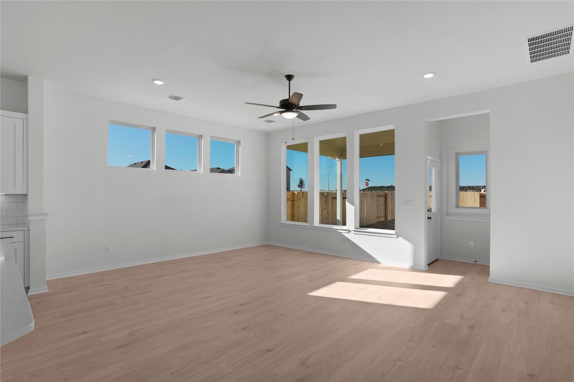 237 Wingstem Way Georgetown, TX 78633 - Photo 30 of 40 a view of a livingroom with a chandelier fan and windows