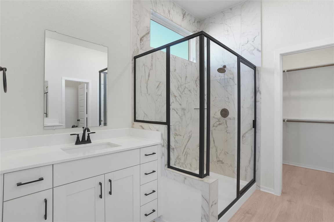 237 Wingstem Way Georgetown, TX 78633 - Photo 34 of 40 a bathroom with a shower sink and mirror