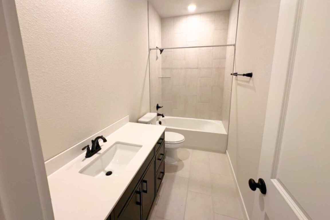 237 Wingstem Way Georgetown, TX 78633 - Photo 3 of 40 a bathroom with a tub sink a mirror and shower