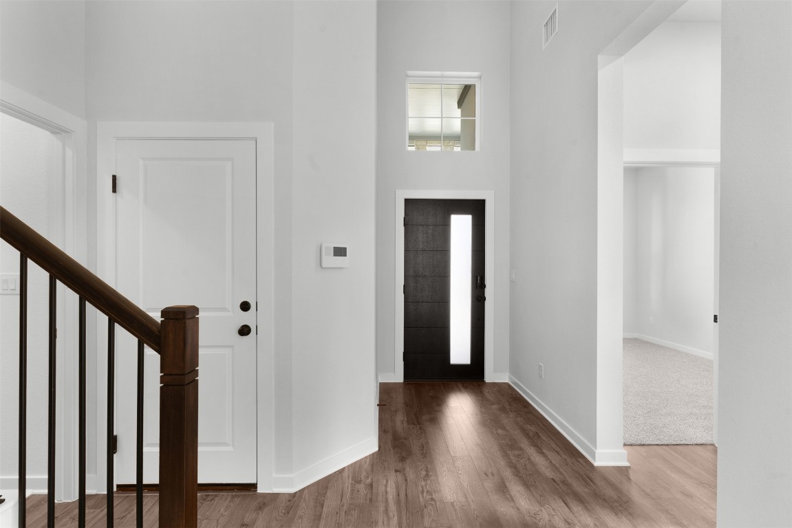 237 Wingstem Way Georgetown, TX 78633 - Photo 3 of 26 Foyer with stairs, wood finished floors, and a towering ceiling